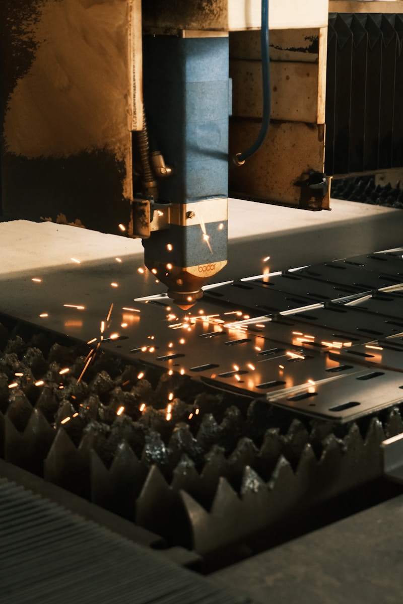 A machine cutting a piece of metal with sparks